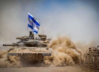 Knesset committee urges Netanyahu to implore Trump to change part of US aid deal Israeli Merkava tank pull back from the Gaza Strip near the border with Israel on Aug. 3, 2014. Photo by Flash90