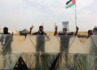 On Facebook: Gazan protestors ‘bring a knife, dagger, handgun,’ kidnap Israelis, murder soldiers Palestinian protesters clash with Israeli forces near the Gaza-Israel border on May 14, 2018. Credit: Abed Rahim Khatib/Flash90
