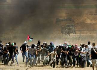 Analysis: Trapped in its own paradox, Hamas is buying time with Gaza protests Palestinian protesters during clashes with Israeli forces along the border with the Gaza strip east of Gaza City on May 11, 2018. Credit: Abed Rahim Khatib/Flash90