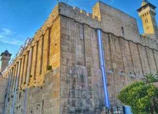Swiss ambassador issues lukewarm apology to Hebron Jews after activist slaps child Israel flags decorate the 2,000-year-old Tomb of Machpelah complex in Hebron in anticipation of Yom Ha’atzmaut. The same Herodian masonry is used for the Western Wall in Jerusalem. Photo by Yishai Fleisher.