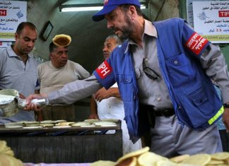 Hebron Jewish community calls on Netanyahu to throw out international observers An international observer assists Palestinian shop owners in the old city of Hebron while preparing Ramadan sweets, Aug. 12, 2010. Photo by Najeh Hashlamoun/Flash90.