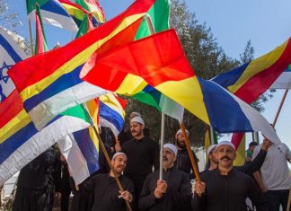Nation State Law is a step toward apartheid Druze men protest outside the Hafia District Court, carrying both the Druze and the Israeli flags. Photo by Flash90.