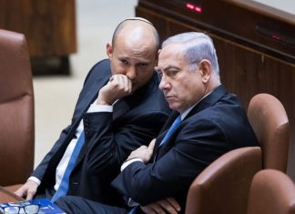 Bennett walks back ultimatum, coalition remains intact Israeli Prime Minister Benjamin Netanyahu speaks with Education Minister Naftali Bennett during a plenum session in the assembly hall of the Israeli parliament on Nov. 13, 2017. Photo by Yonatan Sindel/Flash90.