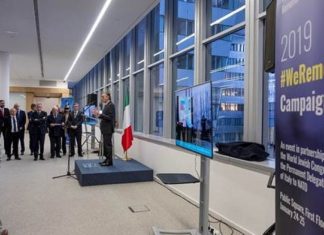 World Jewish Congress partners with NATO to raise Holocaust awareness Italian Ambassador to NATO Claudio Bisogniero speaks at the NATO headquarters alongside a screen projecting #WeRemember photo via live stream from Auschwitz-Birkenau. Credit: NATO.