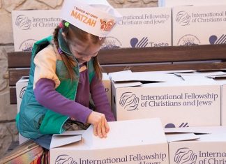 International Fellowship to help 120,000 Jews in former Soviet Union with Passover A young girl helps pack boxes containing food and other items to be sent to Jews in need. Credit: Federation of the Jewish Communities of the Commonwealth of Independent States.