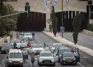 Knesset holds ‘Every Person Has a Name’ Holocaust remembrance ceremony Blue and White Party chairman and Knesset member Benny Gantz lights a memorial candle with his sons during a Holocaust Remembrance Day ceremony at the Knesset in Jerusalem, May 2, 2019. Photo by Hadas Parush/Flash90.