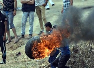 Palestinians announce ‘popular uprising’ against Trump peace plan Palestinians burn tires to throw over the Gaza border into Israel on May 4, 2018, as part of weekly riots led by Hamas since March 30. Credit: Wikimedia Commons.