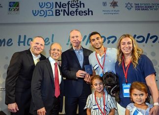 60,000th new immigrant to Israel on 60th Nefesh charter flight Evan Gershater, the 60,000th immigrant to Israel brought by Nefesh B’Nefesh, is given an Israeli identity card by Minister of Aliyah and Integration Maj. Gen. (ret.) Yoav Galant, and Nefesh B’Nefesh co-founders Rabbi Yehoshua Fass and Tony Gelbart. Photo by Shahar Azran.