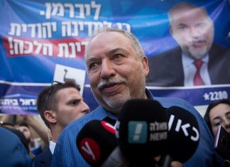 Lieberman urges unity government after his party receives boost in exit polls Yisrael Beiteinu Party leader Avigdor Lieberman speaks to press while touring the Sarona Market in Tel Aviv during the second round of Israeli elections on Sept. 17, 2019. Photo by Miriam Alster/Flash90.