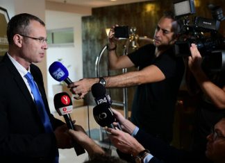 Likud, Blue and White negotiators meet for coalition talks Israeli Tourism Minister Yariv Levin of the Likud Party arrives at a meeting with the Blue and White Party for negotiations after Blue and White leader Benny Gantz was given the mandate to form a government, at the Kfar Maccabiah Hotel in Ramat Gan, on Oct. 27, 2019. Photo by Tomer Neuberg/Flash90.