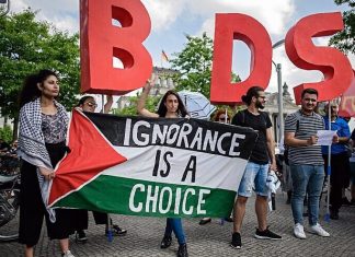 ‘UN sponsoring pro-BDS groups,’ right-wing watchdog claims Protesters in Berlin hold a Palestinian flag and the initials of the anti-Israel BDS movement while Israeli Prime Minister Benjamin Netanyahu was visiting Germany in August 2019. Credit: Israel Hayom.