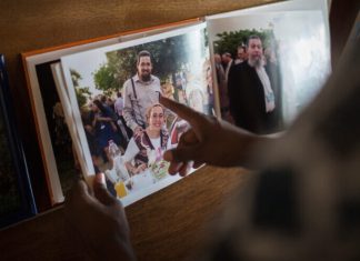 US court finds Iranian banks liable for deadly terror attack against US citizens Friends and family look at pictures of Eitam and Na'ama Henkin, an Israeli couple shot and killed in Itamar, at their shiva in Jerusalem on Oct. 7, 2015. Photo by Hadas Parush/Flash90.