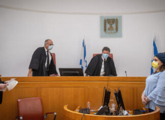 Will Israel’s politicized Supreme Court stick to law on Palestinian Sheikh Jarrah squatters? Israeli Supreme Court justice Yitzhak Amit (center) attends a petition regarding the evacuation of Palestinian families from their home in Sheikh Jarrah neighborhood, at the Supreme Court in Jerusalem on Aug. 2, 2021. Photo by Yonatan Sindel/Flash90.