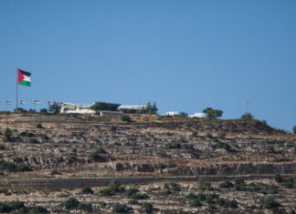 Palestinians building new neighborhood inside Jerusalem View of the Palestinian flag in the Palestinian city of Rawabi, as seen from the the Jewish settlement of Ateret, in the Binyamin District in the West Bank, July 11, 2018. Photo by Hadas Parush/Flash90.