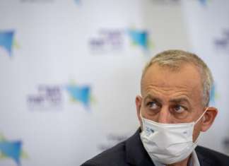 Israel to end ban on incoming travelers amid rapid uptick in COVID infections Director-general of Israel’s Ministry of Health Nachman Ash speaks during a press conference about new COVID restrictions, in Jerusalem on Dec. 12, 2021. Photo by Yonatan Sindel/Flash90.