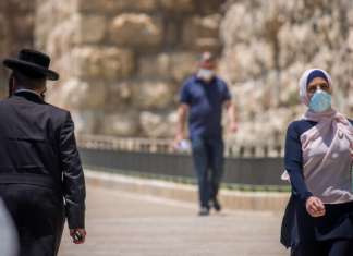Amnesty International should be ashamed Arabs and Jews walk by the Jaffa Gate of the Old City of Jerusalem, July 5, 2020. photo by Yonatan Sindel/Flash90.