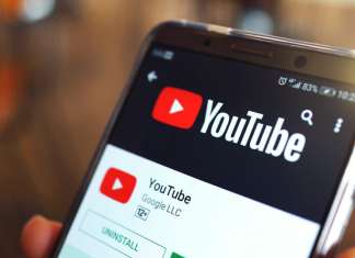 UK, Jewish groups demand YouTube remove sermons inciting anti-Semitism Illustration: a person holding a smartphone with the YouTube app open. Credit: AngieYeoh/Shutterstock.