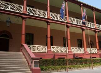 Australia’s New South Wales considers ban on public displays of swastikas The facade of New South Wales parliament house on Macquarie Street with Australian, New South Wales and aboriginal flags raised. Credit: Demamiel62/Shutterstock.