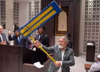 Hungarian Jews mark Purim with Ukrainian refugees, stressing peace Ukrainian refugees and their hosts celebrate Purim with a reading of the Megillah and the shaking of a grogger in the national colors of Ukraine at the Zsilip Jewish Cultural Centre and Synagogue in Budapest, Hungary, March 17, 2022. Photo by Zsolt Demecs.