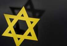 ‘Gospels of Hate’ Yellow Star of David with shadow on black background. Credit: Ausra Barysiene/Shutterstock.