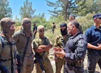 Two arrested in connection with Elad terror attack Israel Police Commissioner Yaakov Shabtai (second from right) talks with members of the Israeli forces participating in the search for the terrorists who murdered three people in the city of Elad on May 5, 2022, in this image posted on social media on May 8, 2022. Source: Israel Police Twitter.