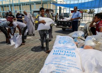 UNRWA criticized for failure to dismiss teachers involved in anti-Jewish incitement Palestinians receive food aid at an UNRWA distribution center in the southern Gaza Strip town of Rafah on May 26, 2021. Photo by Abed Rahim Khatib/Flash90.