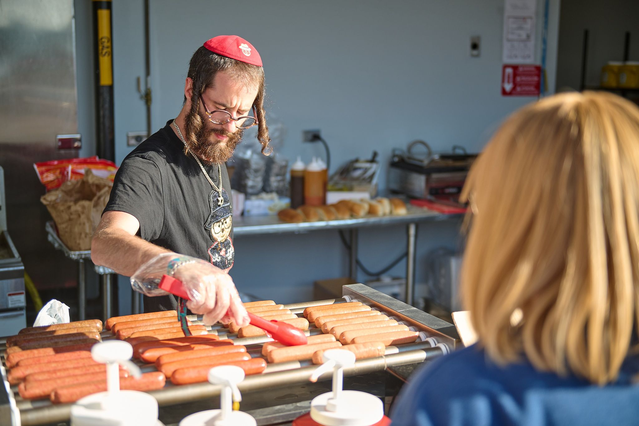 Chaim Lungar of Pomona, N.Y., serves up kosher hot dogs at Clover Stadium in Rockland County, N.Y., where the New York Boulders played the Evansville Otters on Jewish Heritage Day, July 30, 2023. Photo by Perry Bindelglass.