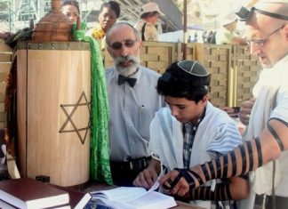 Activist seeks to burn Torah outside Israeli embassy in Sweden A bar mitzvah boy reads his Torah portion at the Western Wall in Jerusalem. Photo by Peter van der Sluijs via Wikimedia Commons.