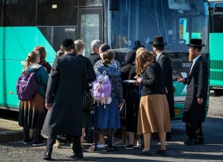 Netanyahu condemns discrimination against women on buses Ultra-Orthodox Jews board the bus to the Lag B'Omer festivities at Mount Meron in the Upper Galilee, May 8, 2023. Photo by Arie Leib Abrams/Flash90.
