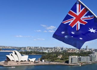 Canberra to resume use of term ‘occupied Palestinian territories’ The Australian flag flies above Sydney Harbor and the city's Opera House. Credit: ChameleonsEye/Shutterstock.