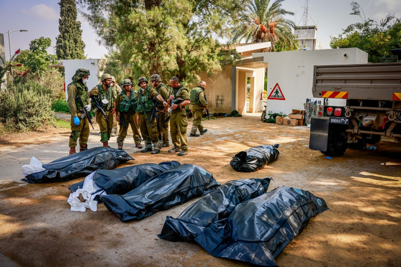 Israeli soldiers remove bodies in Kibbutz Kfar Aza in southern Israel, Oct. 10, 2023. Photo by Chaim Goldberg/Flash90.
