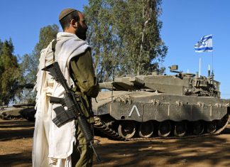 US Jews supply thousands of tzitzit to Israeli soldiers An Israeli soldier during morning prayers near the border with Lebanon, Oct. 25, 2023. Photo by Michael Giladi/Flash90.