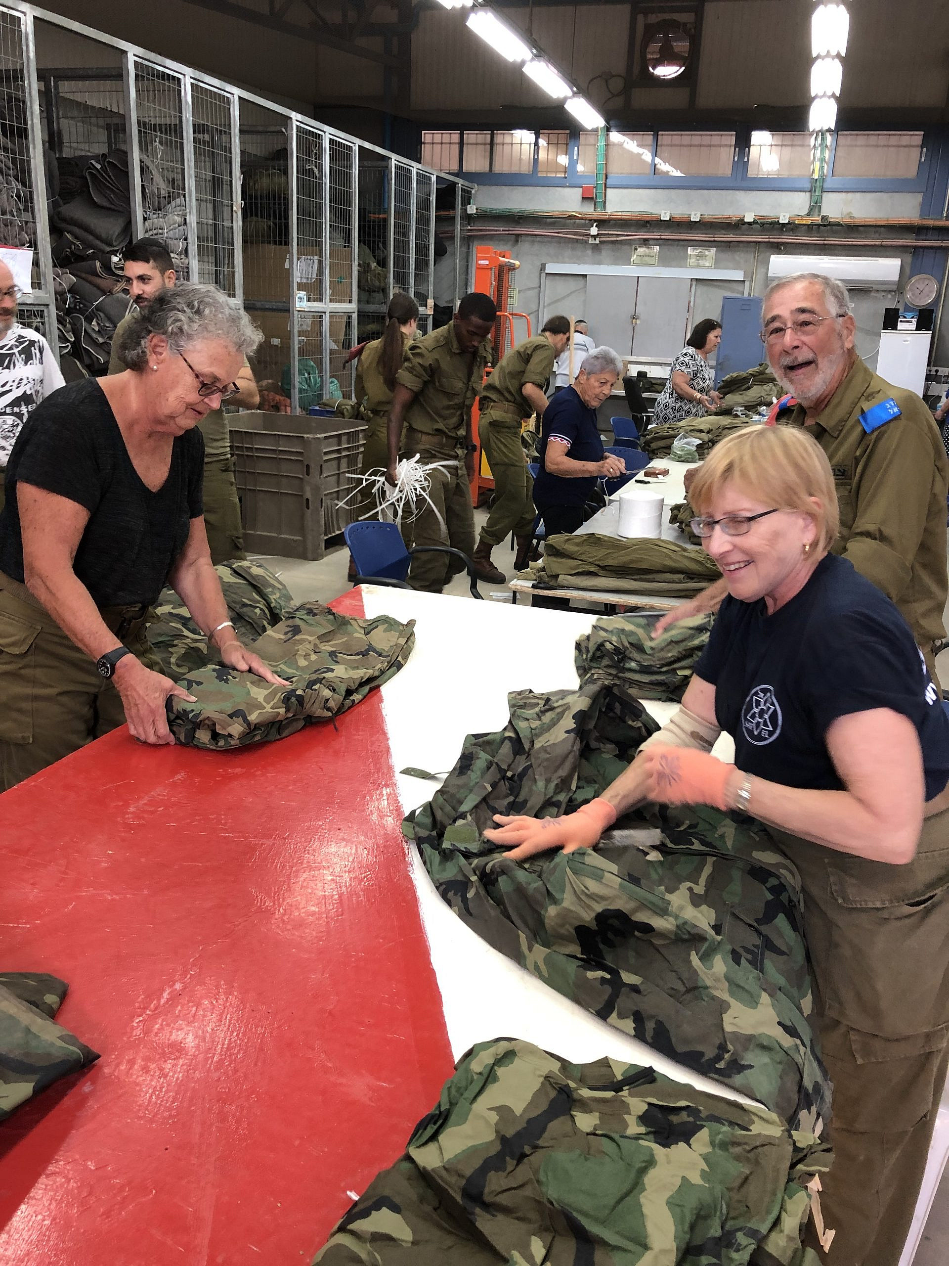 Participants in the Volunteers for Israel program pack winter rain gear for soldiers in the Israel Defense Forces. Credit: Courtesy.