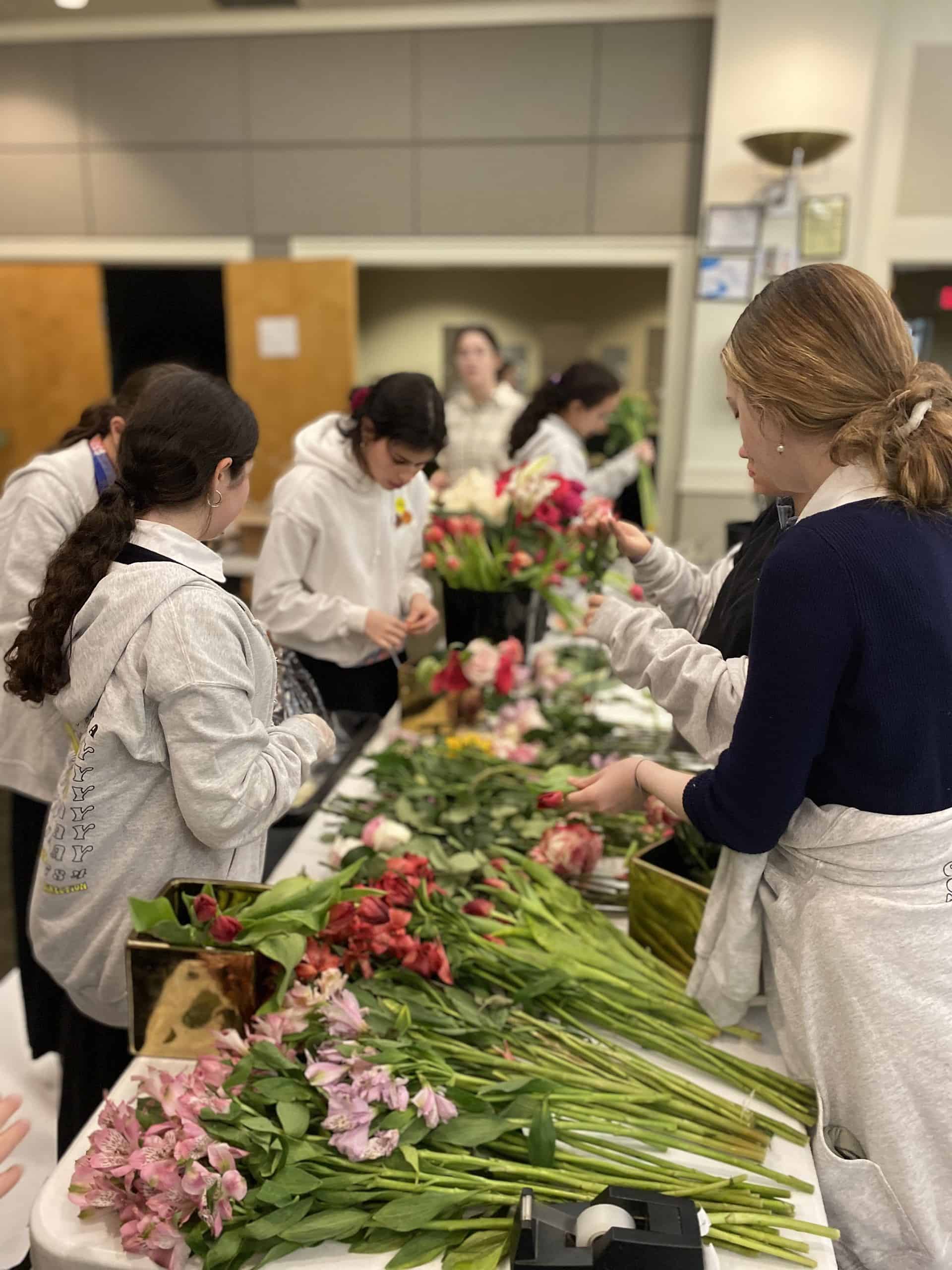 Temima High School students prepare flowers for Block Party Kiddush at Beth Jacob Atlanta, which took place during the Shabbat Project. Credit: Courtesy of Beth Jacob Atlanta.