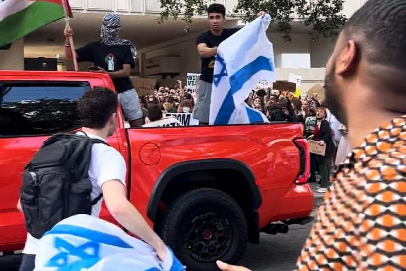 Anti-Israel protesters start to burn an Israeli flag during a rally at Tulane University in New Orleans on Oct. 26, 2023. Photo by Pnina Sasson.