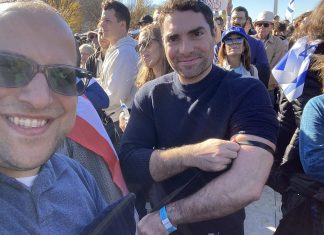 Jewish great awakening follows Oct. 7 terror attacks The comedian Eli Lebowicz (left) helped fellow participants at the "March for Israel" wrap tefillin on Nov. 14, 2023. Credit: EliComedy.com.