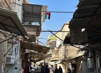 Jerusalem police remove vandalism supporting Hamas massacre A PLO flag hangs in Jerusalem's Mea Shearim neighborhood. Credit: Israel Police.