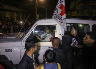 Refusing to leave captivity without her husband, Hamas threatened her Hamas terrorists release Israeli hostages to the Red Cross in the Gaza Strip, Nov. 28, 2023. Credit: Flash90.