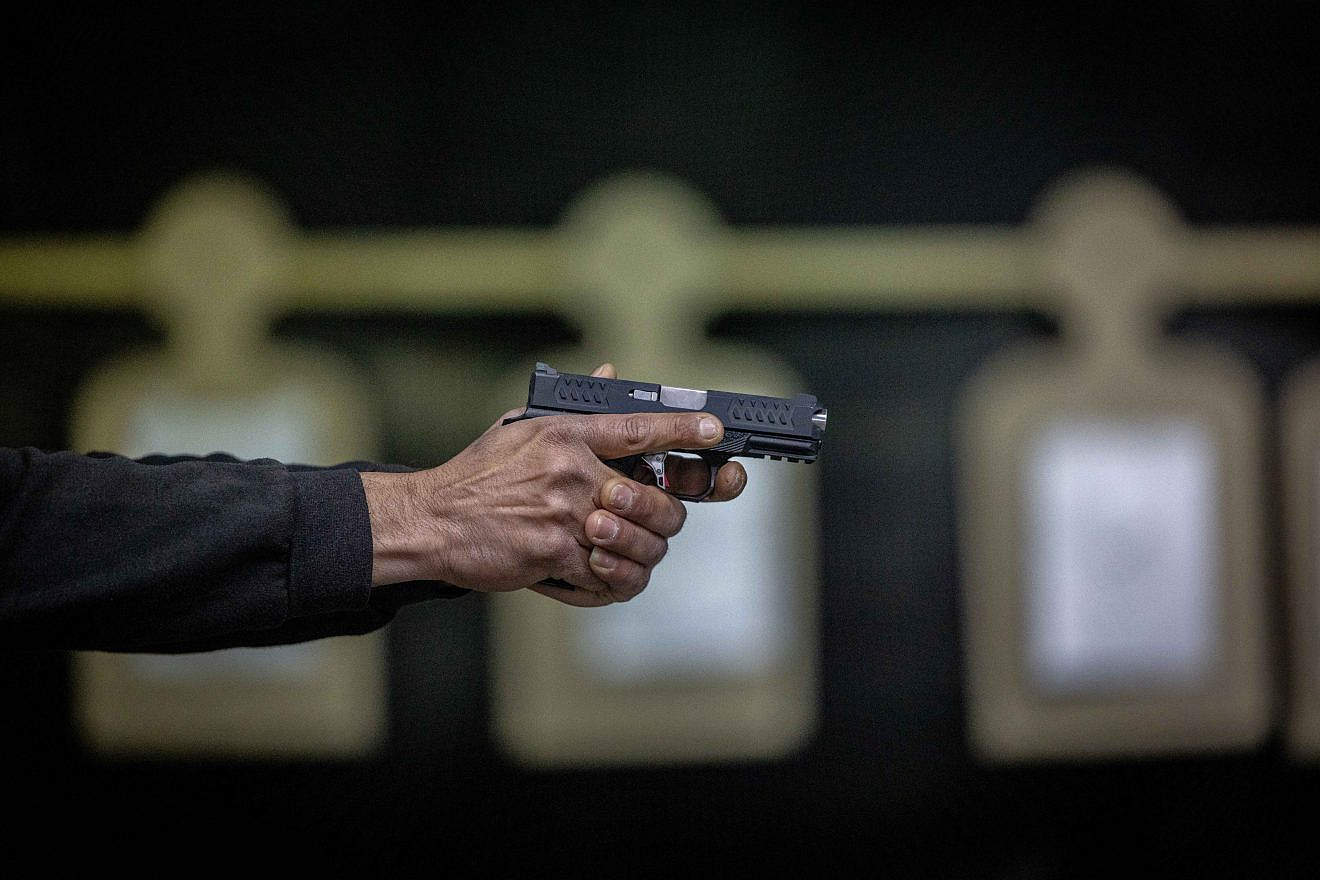 An Israeli practices with a handgun at a Jerusalem shooting range, following the recent wave of terror attacks in Israel, April 3, 2022. Photo by Yonatan Sindel/Flash90.
