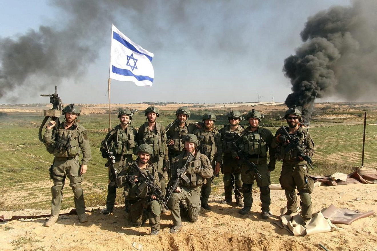 Members of the IDF Paratroopers Reconnaissance Battalion, including Haim Brenner (standing at left) and Netanel Sharvit (standing, fourth from left), in the Gaza Strip. Photo: Courtesy.
