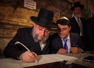 Former Moscow chief rabbi, European Jewry win Charlemagne Prize Then-Chief Rabbi of Moscow Pinchas Goldschmidt helps to write a new Torah scroll in the Western Wall tunnels in Jerusalem, May 21, 2014. Photo by Flash90.