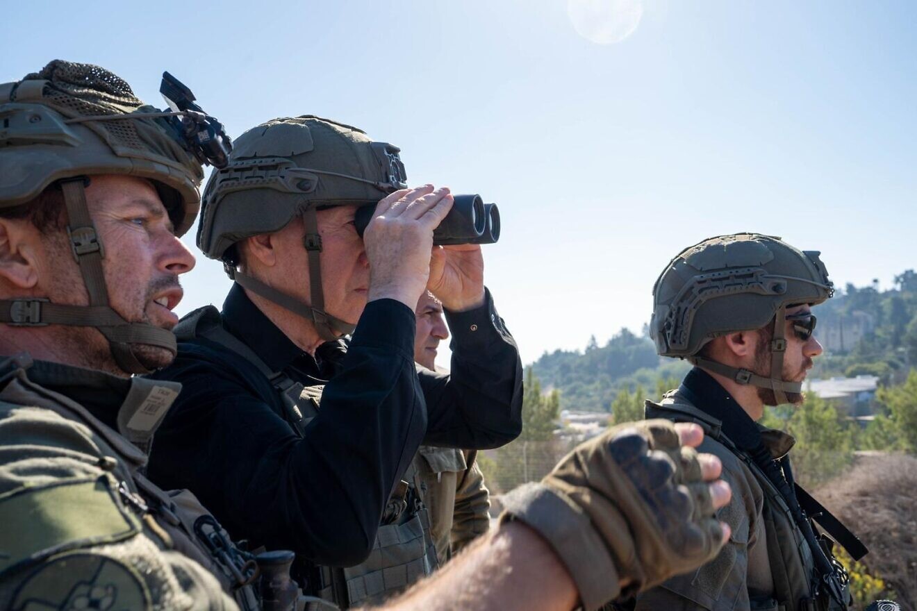 Defense Minister Yoav Gallant (with binoculars) observes Hezbollah positions in Southern Lebanon from northern Israel, Oct. 13, 2024. Photo by Ariel Hermoni/IMoD.