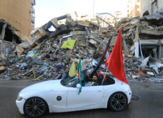 Israel-Lebanon ceasefire takes effect, ending more than a year of war A driver waves the flag of Hezbollah as supporters of the terrorist group parade in Beirut's southern suburbs on Nov. 27, 2024, after a ceasefire between Israel and the Lebanese terrorist group took effect. Photo by AFP via Getty Images.