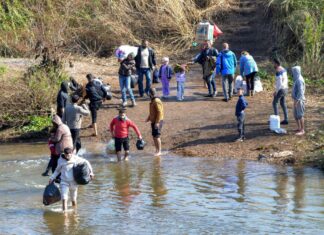 New Syrian regime’s ‘mask has fallen’ Alawites cross the Nahr al-Kabir river, forming the border between Syria's western coastal province and northern Lebanon in the Hekr al-Daher area, fleeing sectarian violence in their heartland along Syria's Mediterranean coast, on March 11, 2025. Photo by Fathi al-Masri/AFP via Getty Images.