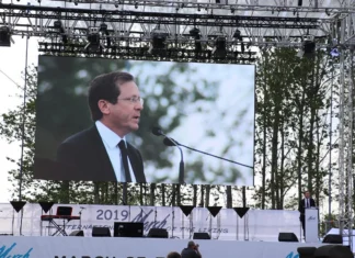 Herzog to lead March of the Living with freed hostages Then-Jewish Agency chairman Isaac Herzog speaks at the annual March of the Living program in Poland on May 2, 2019. Credit: Jewish Agency for Israel.