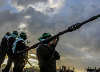 Israel, Syria and the false legality of jihadi terror Hamas terrorists amid a transfer of four bodies of Israeli hostages, whom Hamas murdered, to Israel, Gaza, Feb. 20, 2025. Credit: Abed Rahim Khatib/Flash90.