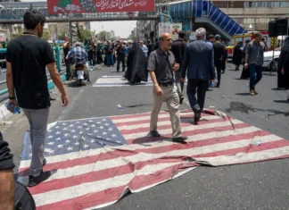 Top Iranian cleric issues fatwa against Trump People walk on an American flag on the street as thousands of Iranians attend the funeral ceremony for approximately 60 people killed in Israeli strikes on Iran, including high-ranking military officials, nuclear scientists, and civilians, during a state funeral service in Enqelab Square on June 28, 2025 in Tehran, Iran. Photo by Majid Saeedi/Getty Images.