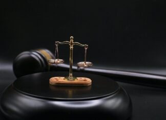 Auto manufacturer sued for antisemitic workplace discrimination The scales of justice on top of a gavel's block. Credit: Sergei Tokmakov/Pixabay.