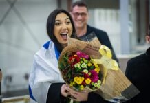 Will Israel participate in Eurovision 2026? Yuval Raphael arrives at Ben-Gurion International Airport after competing in the Eurovision Song Contest, where she finished in second place, May 18, 2025. Photo by Yonatan Sindel/Flash90.