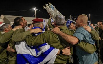IDF soldiers dance with Torah at Nova festival massacre site Israeli soldiers and Jewish men carry Torah scrolls as they dance during Simchat Torah celebrations at a military base on the border with the Gaza Strip on Oct. 14, 2025. Photo by Tsafrir Abayov/Flash90.